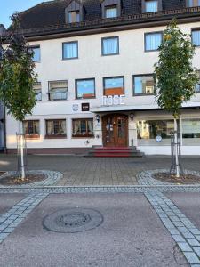 a large white building with a building at Hotel Goldene Rose in Ebersbach an der Fils