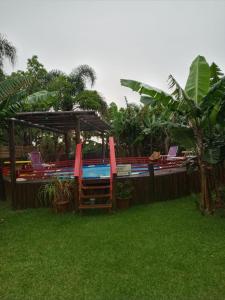 a backyard with a pool and chairs and a fence at Morada Vista da Lagoa in Garopaba