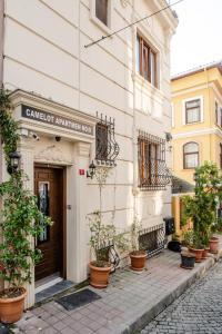 a building with potted plants in front of it at Camelot Apartment in Istanbul