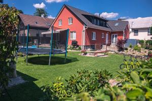 a house with a trampoline in the yard at Red Pine Apartments in Vlachovice