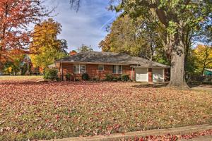 a house with a pile of leaves on the ground at Ranch-Style Cottage - 2 Miles to Philbrook Museum! in Tulsa