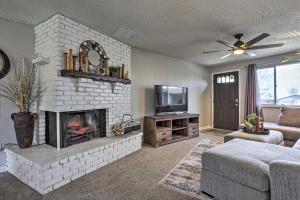 a living room with a fireplace and a tv at Duplex with Private Yard 3 Mi to Downtown Loveland! in Loveland
