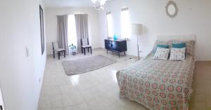 a living room with a bed and a table and chairs at beatiful house in Vuelta de Obligado +5 photos