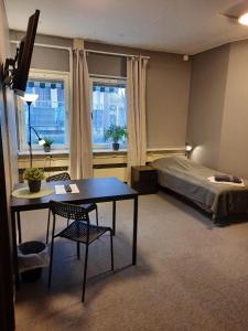 a bedroom with a bed and a table and a desk at Vandrarhem Uppsala - Portalgatan in Uppsala