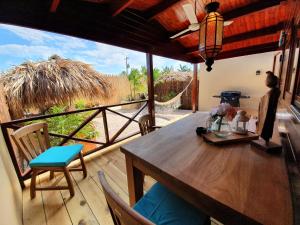 a dining room with a table and chairs on a deck at Bamboo Bonaire Boutique Resort in Kralendijk