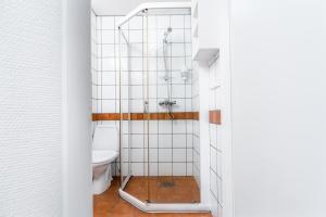 a bathroom with a shower and a toilet at Birkebeineren Hotel & Apartments in Lillehammer