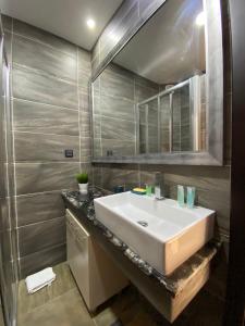 a bathroom with a white sink and a mirror at Milmari Mountain view - I11 in Kopaonik