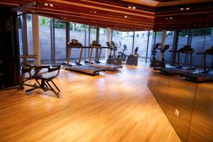 a gym with several treadmills and chairs in a room at Baan San Kraam 5206 Cha-am Hau Hin in Cha Am