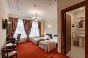 a hotel room with two beds and a bathroom at Sonata Nevsky 5 Palace Square in Saint Petersburg