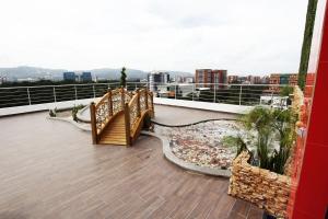 a balcony with a wooden staircase and a view of the city at Suites Terraza Imperial in Guatemala