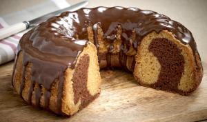 a chocolate bundt cake sitting on a cutting board at Kyknos De Luxe Suites & Rooms in Kastoria