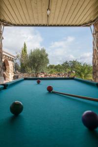 a pool table with balls on top of it at Finca Jabali in Tortosa