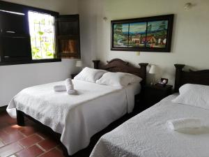 เตียงในห้องที่ Hotel Casa Claustro De Zapatoca