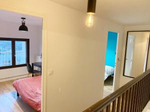 a room with a stairway leading to a bedroom at 014 CHIC & COSY GRAND APPART DUPLEX 76m2 WIFI SMART TV NETFLIX ET VUE PANORAMIQUE in Saint-Étienne