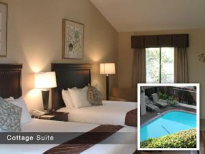 a hotel room with two beds and a pool at Adobe Inn in Carmel