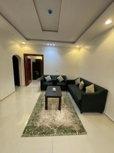 a living room with a couch and a coffee table at ابيات ميرا in Abha