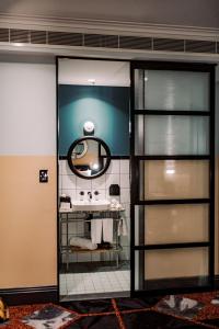 a bathroom with a sink and a mirror at Stay at Hotel Steyne in Sydney