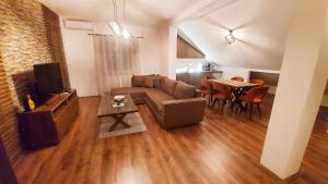 a living room with a couch and a table at Gold Apartment in Strumica