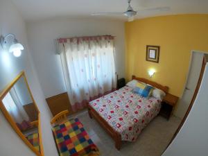 Habitación pequeña con cama y ventana en Hotel Dany en Santa Teresita