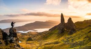 a man standing on top of a mountain at Loch Eyre Shepherd Hut in Portree