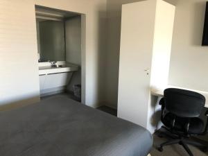 a room with a bed and a desk and a chair at BestWay Inn Oklahoma City Airport in Oklahoma City