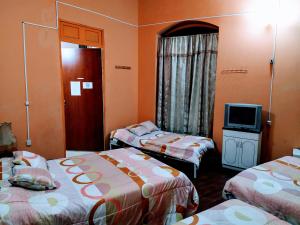 Postel nebo postele na pokoji v ubytování Hostal Latitud Ecuem