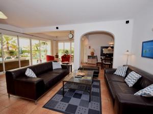 a living room with leather couches and a table at Fantastic Villa in Albufeira with Private Swimming Pool in Albufeira