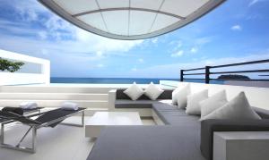 a living room with a view of the ocean at Kata Rocks - SHA Extra Plus in Kata Beach