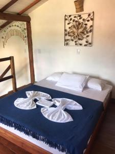 מיטה או מיטות בחדר ב-Pousada Villa Cachoeira