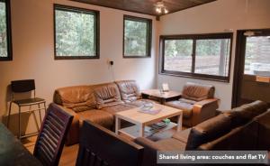 a living room with a couch and a table at Guest House Preta Torami in Ichinomiya