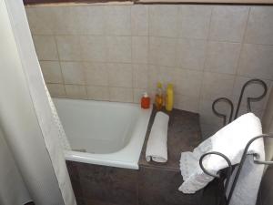 a bathroom with a white bath tub in a room at Kiritina´s House Homestay in El Calafate +50 photos