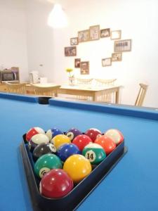 a bin of billiard balls on a pool table at The Gatherings Place in Melaka