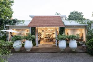 a group of large white vases with plants in them at Raya Heritage - SHA Plus in Chiang Mai