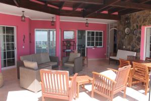 a patio with chairs and a couch and a table at Villa Dara in Playa del Ingles