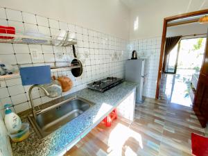 a kitchen with a sink and a counter top at Phu My Hung Bungalow in Phú Quốc