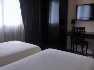 Postel nebo postele na pokoji v ubytování Hotel Patavium