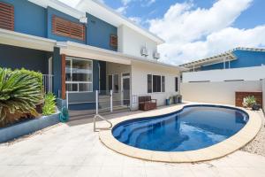 a large swimming pool in front of a house at Marina Beach Holiday Home in Cremorne