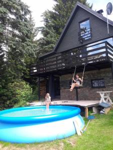 a woman and a girl on swings in a pool at Chata 100 Český Jiřetín in Český Jiřetín