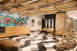 a room with a checkered floor and a painting on the wall at ARTOTEL Yogyakarta in Yogyakarta