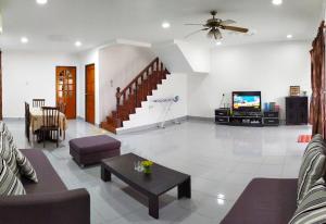 a living room with a couch and a tv at Victoria Homestay Sibu - Next to Shopping Complex, Party Event & Large Car Park Area with Autogate in Sibu