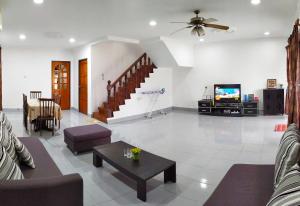 a living room with a couch and a tv at Victoria Homestay Sibu - Next to Shopping Complex & Large Car Park Area with Autogate in Sibu