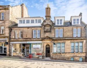 an old building on the corner of a street at Carvetii - Edward House A - 2 Dbl bed 1st floor flat in Dunfermline