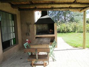 a fireplace on the patio of a house at La Pausa Lodge de Campo in Duggan