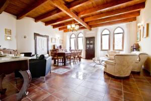 a living room with chairs and a dining room at Ospitalità Don Carlo in Tortorella