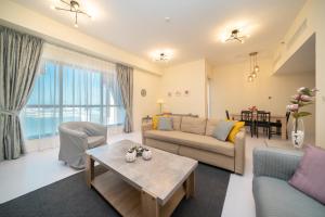 a living room with a couch and a table at HiGuests - Fantastic Sea Views Apt in JBR by the Beach in Dubai