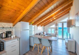 a kitchen with a table and chairs in a room at Amore Del Mare in Amoudi