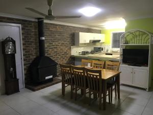 a kitchen with a table and a wood stove at Convenience house in Nerang with Private room in Gold Coast