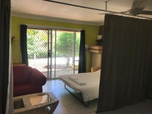 a bedroom with a bed and a sliding glass door at Convenience house in Nerang with Private room in Gold Coast