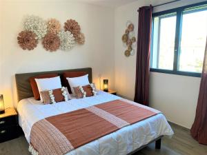 a bedroom with a large bed and a window at Villa Coconing à 7min des plages - Piscine chauffée - Clim - BBQ - Parking privatif - Fibre in Porto-Vecchio +34 photos