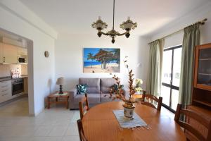 a living room with a table and a couch at Apartamentos Carruna in Albufeira
